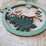 Load image into Gallery viewer, Set of 2 Wooden Ornaments in a Christmas Ball Shape with a 3D Effect Hand-painted Winter Wonderland with reindeer Christmas forest
