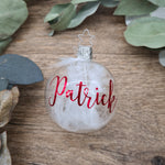 Load image into Gallery viewer, Clear blown glass filled with white feathers and personalized with metallic red
