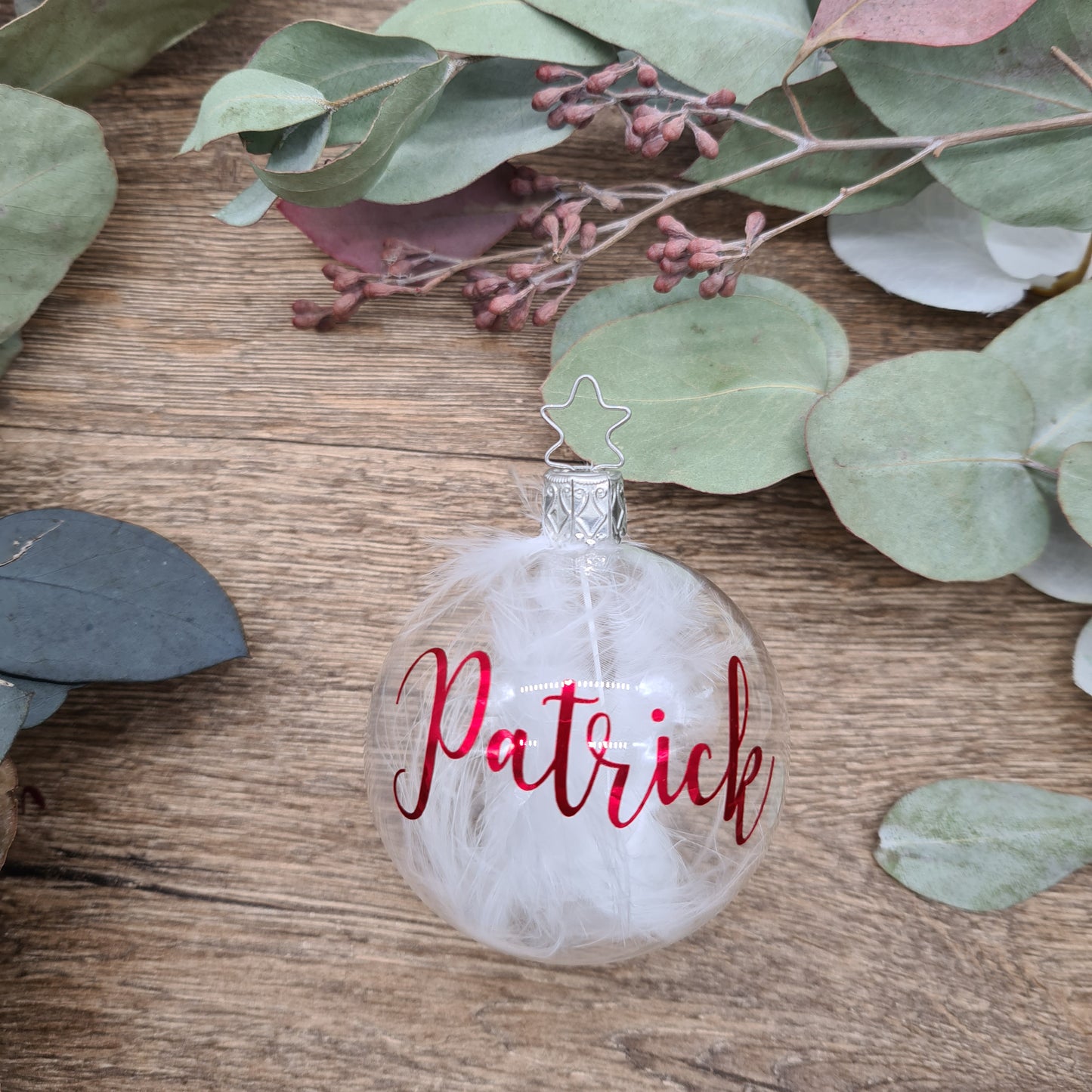 Klares mundgeblasenes Glas, gefüllt mit weißen Federn und personalisiert mit metallischem Rot