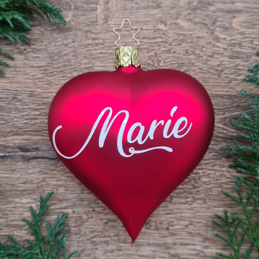 Red heart-shaped glass Christmas bauble with white text